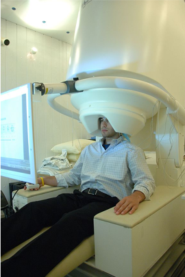 Image of a participant in a MEG scanner.